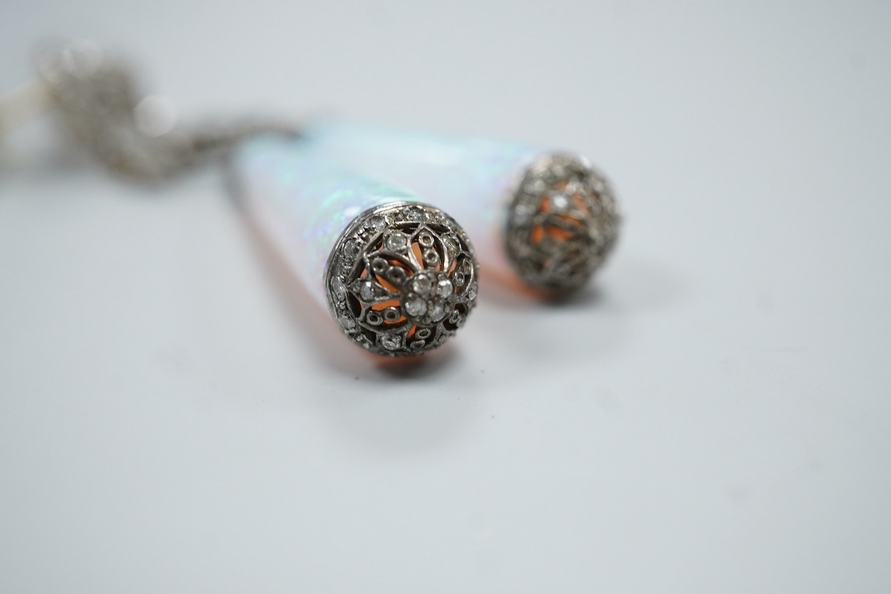 A pair of 1920's style white metal, synthetic opal and diamond chip set drop earrings, 63mm, gross weight 8.2 grams.